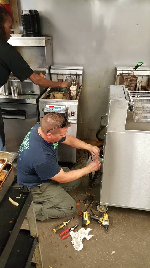 Tech repairing fryer