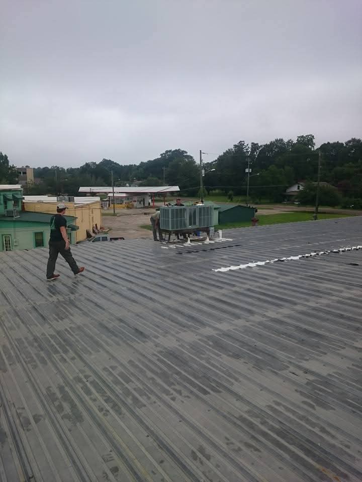 Two techs rooftop post crane set