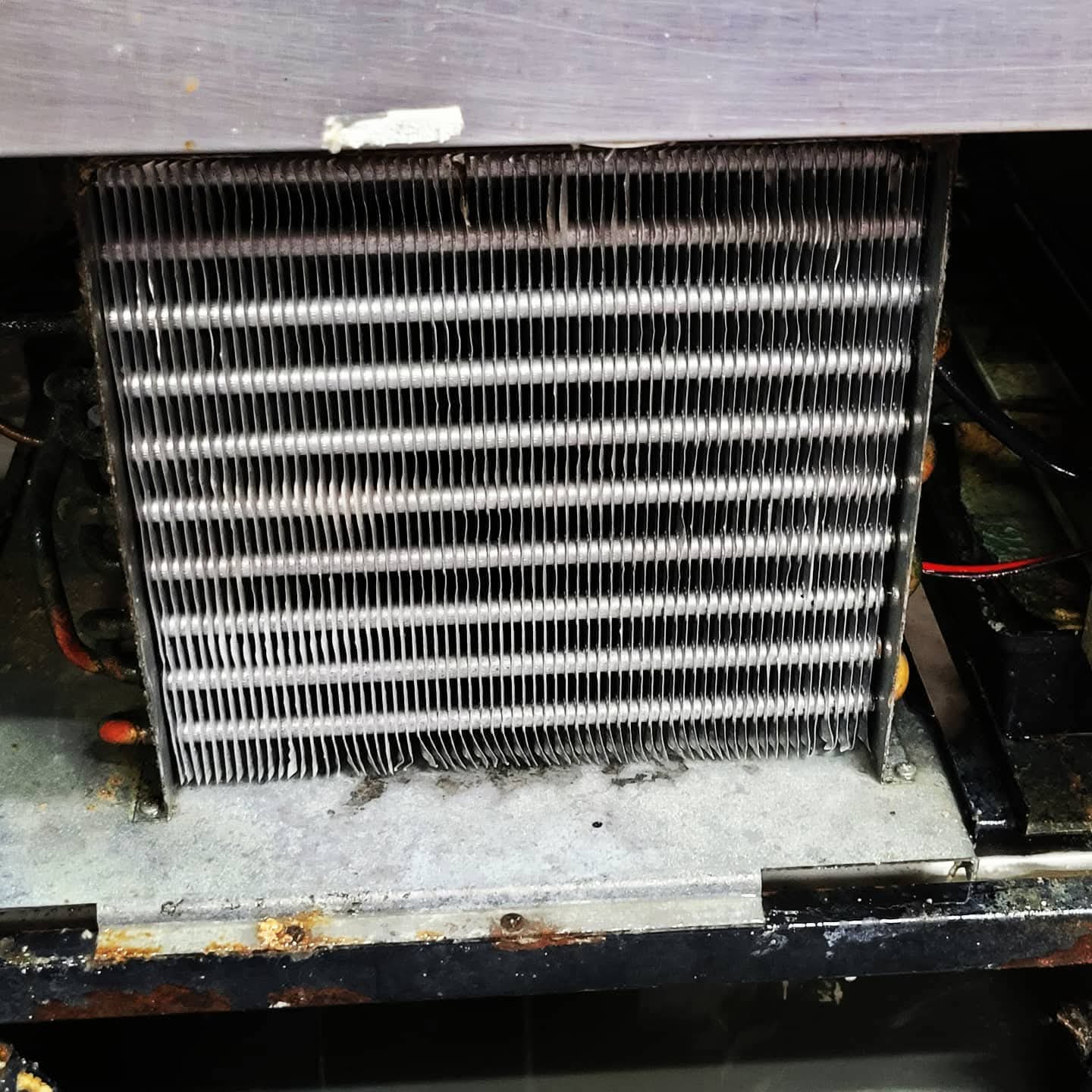 Clean evaporator coil after service — commercial kitchen